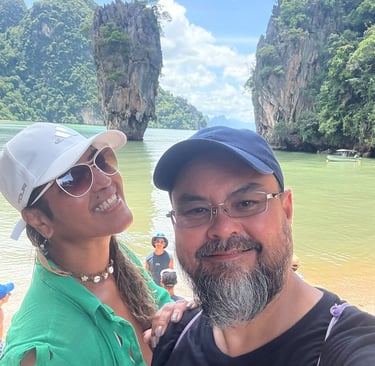 a man and woman standing in front of a boat
