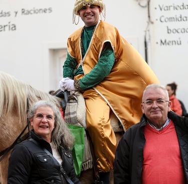 a man in a yellow costume riding a horse