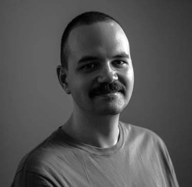 um homem de bigode com um leve sorriso