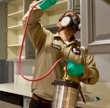 Exterminator on a Cockroach Treatment, inside a kitchen, in Menifee, Footprint Pest Management pest control near me
