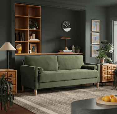 green velvel sofa with wound pillar pillows and thin wooden legs