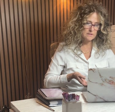 Exhausted nail technician at her station reflecting on nail tech burnout and underpricing