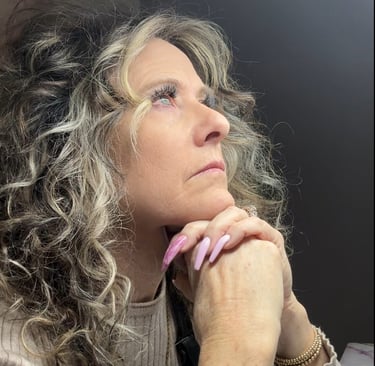 Experienced nail tech looking frustrated at her booking schedule, representing a nail tech income pl