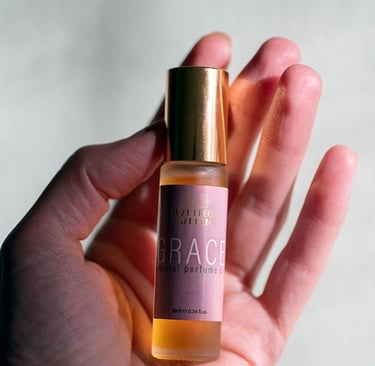 a person holding a bottle of perfume in their hand - Chameleon Garden Perfumery