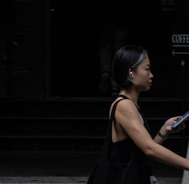 Young Asian Australian woman in gym gear walks along Sydney street