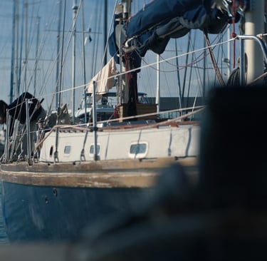 a PERSON is standing on a boat in the water