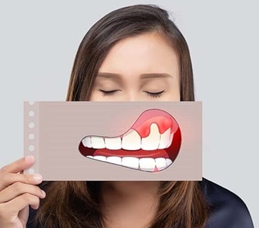 a woman holding a card with a painful smile