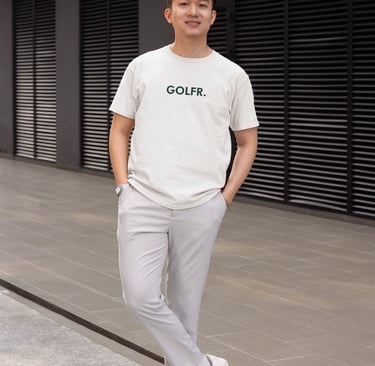 a man in a white shirt and grey pants