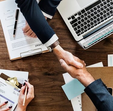 Professional negotiation meeting with salary charts, compensation packages, and handshake representi