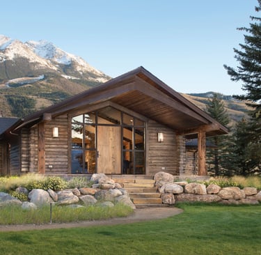 a log cabin with a mountain view of a mountain
