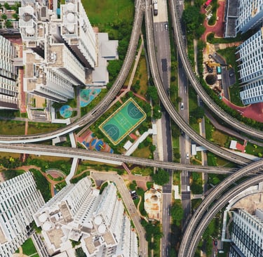 Aerial photograph of urban environment showing skyscrapers, green space, and highways.