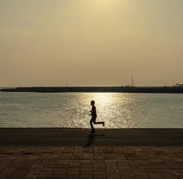 Person running against the background of a harbor Photo by Thilina Alagiyawanna (Pexel.com)