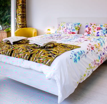 Bed with full bedding, floating bed with two with swimming pool in flower colours at Domaine Des Lucques