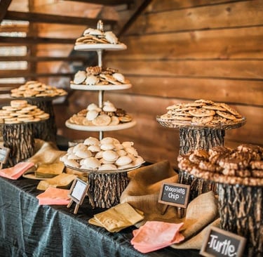 Rustic wedding dessert table catering with assorted cookies on wooden stands in Decatur TX