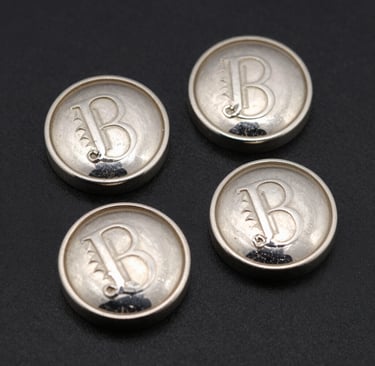 Artisan hands delicately setting a gemstone into a modern, geometric pendant.