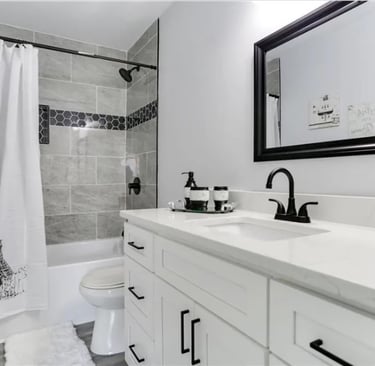 Gray tile walk-in shower with black showerhead in Newport news bathroom renovation