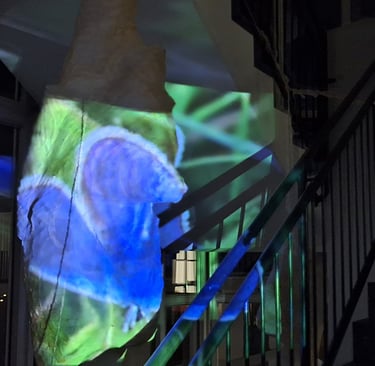 a large blue and green light bulb with a large blue buterfly