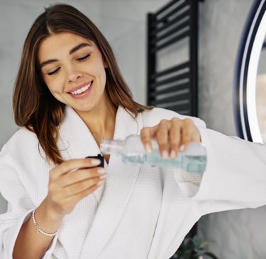 pouring natural mouthwash in a bottle cap