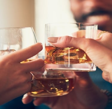 People holding alcohol in the glass