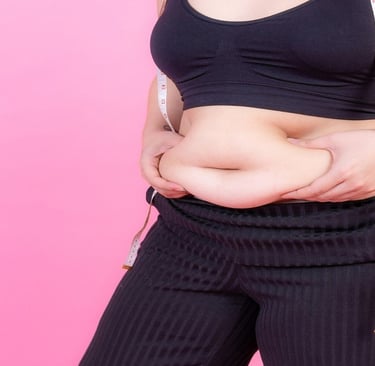 An overweight girl holding belly fat