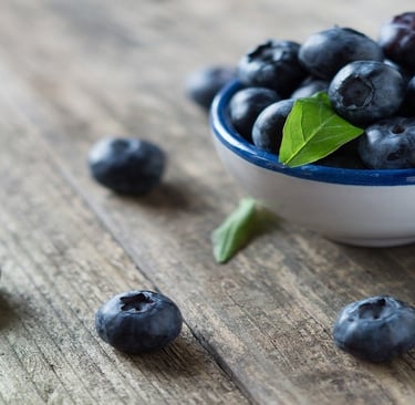 Blueberries in a cup and on the table