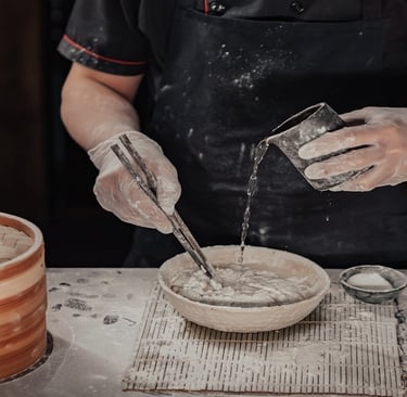 Man pouring water in a flour bowl