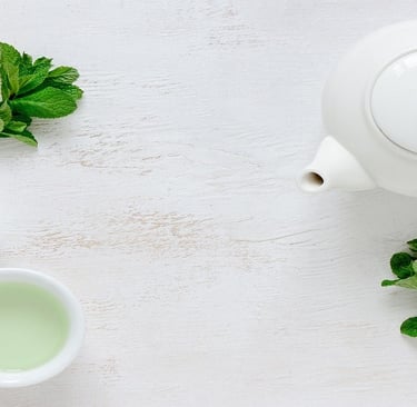 Green Tea in cups and Ceramic Kettle