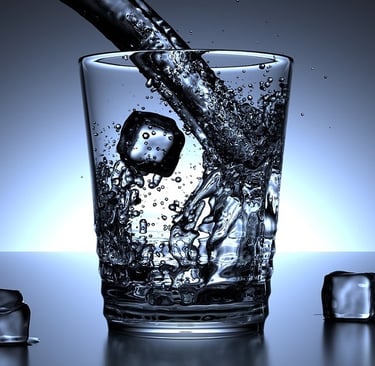 Pouring Water in Glass and Ice Cubes