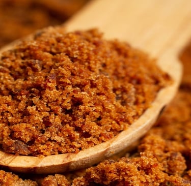 Jaggery on a wooden spatula