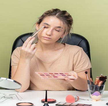 A girl doing makeup with makeup kit