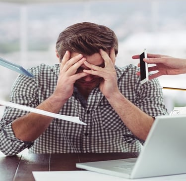 A stressed man sitting in front of laptop