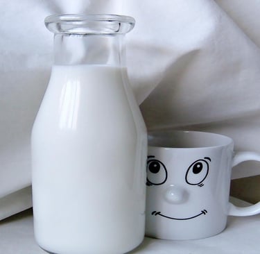 Milk in a glass bottle and a Cup