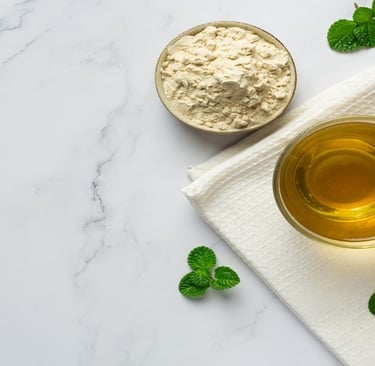 Stevia powder in a bowl, stevia leaves and tea in a glass cup