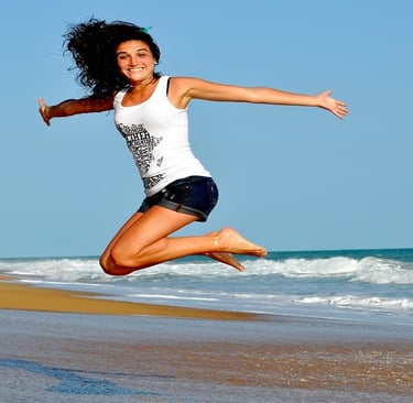 Woman jumping on the beach