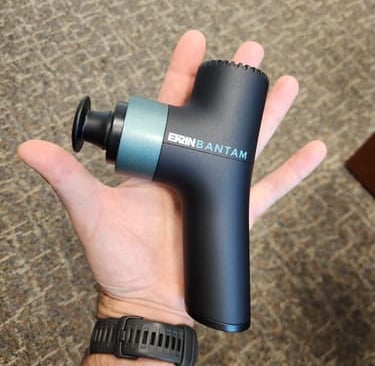 Ekrin Bantam lightweight portable massage gun, offering vibration therapy for gentle muscle relief