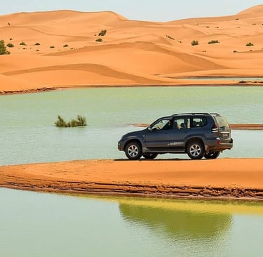 morocco sahara a car parked in a desert with a car in the background