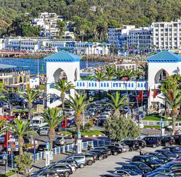 morocco al mediaq a parking lot with cars parked in front of a mountain
