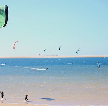 morocco essaouira a couple of people are parasailing in the ocean