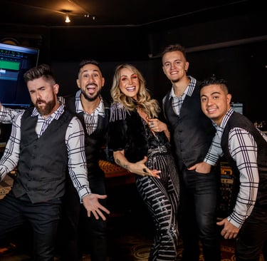 The five members of Mashup Band standing side by side, striking fun poses.