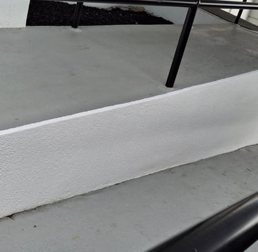Freshly painted handicap access ramp into a dealership.
