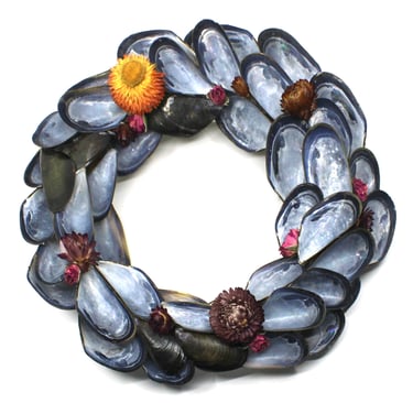 a wreath made of shells and shells with flowers