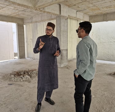 Engineer and architect in Hyderabad discussing construction plans with workers on-site, showcasing t