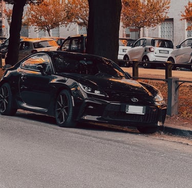 a black car parked on the side of a street
