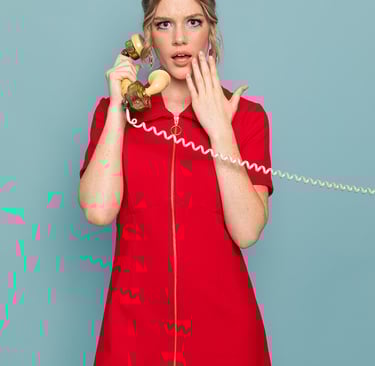 Photo of a Closet Mod brand shoot in Adelaide. Model holds a vintage phone to her ear gasping