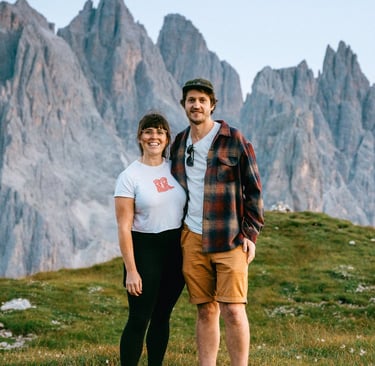 Laura and her partner Sam on a mountain in the Dolomites after filming an elopement on a mountain!