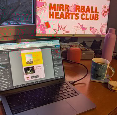 A laptop open to Show It website builder. Mirrorball Hearts Club is being designed on screen.