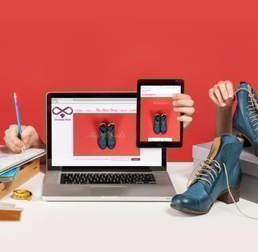uma pessoa sentada em uma mesa com um laptop e uma câmera
