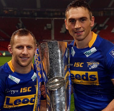 two sports men standing next to each other holding a trophy. Burrow and Sinfield after Leeds Rhinos'