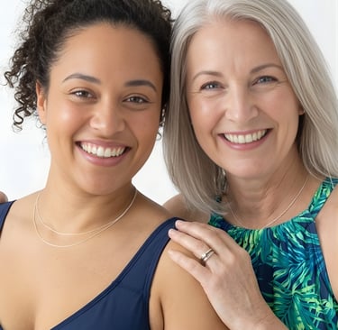 Two diverse smiling women of different ages posing together in summer fashion swimwear.