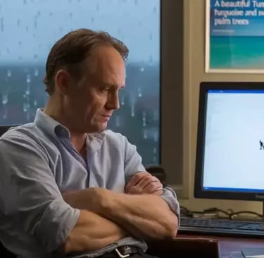 Un homme assis et pensif devant son écran d'ordinateur